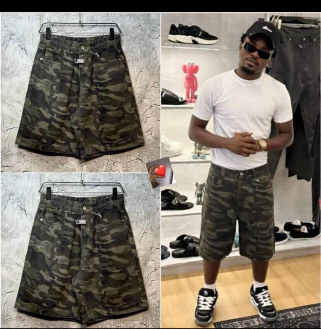 Green camo denim shorts in flat lay views and worn by model with white tee and sneakers.