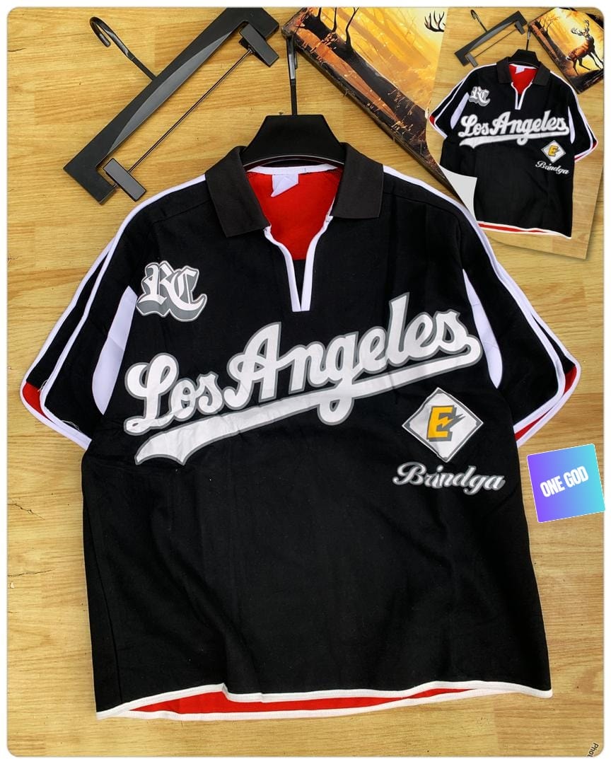 Black Los Angeles Bindga quarter-zip polo shirt on wooden surface.