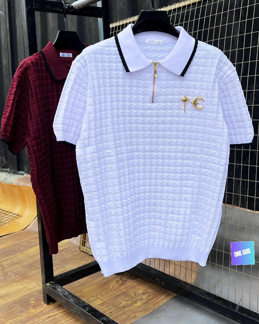 White and maroon textured knit zip polo shirts on clothing rack.