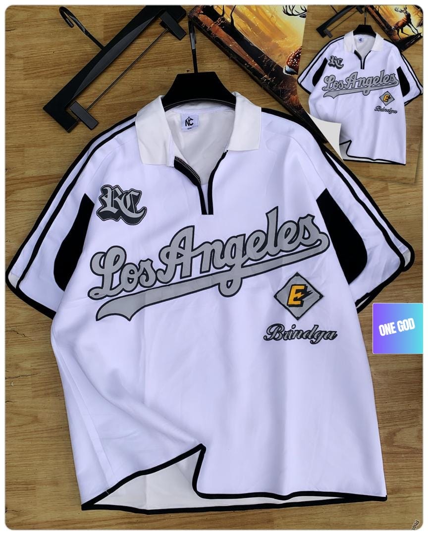 White Los Angeles Bindga quarter-zip polo shirt on wooden surface.