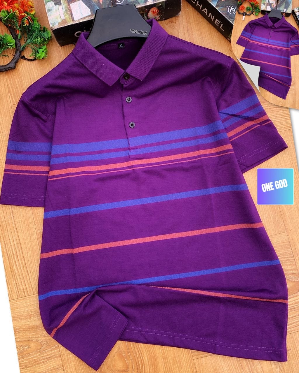 Purple polo shirt with blue and orange stripes laid flat on wooden surface, XL tag visible at collar.