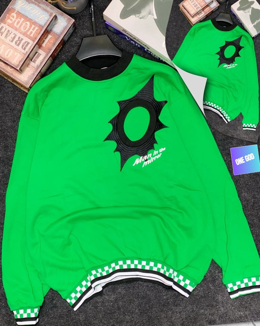 Bright green Man in the Mirror sweatshirt with black embroidered logo and checkered ribbing.