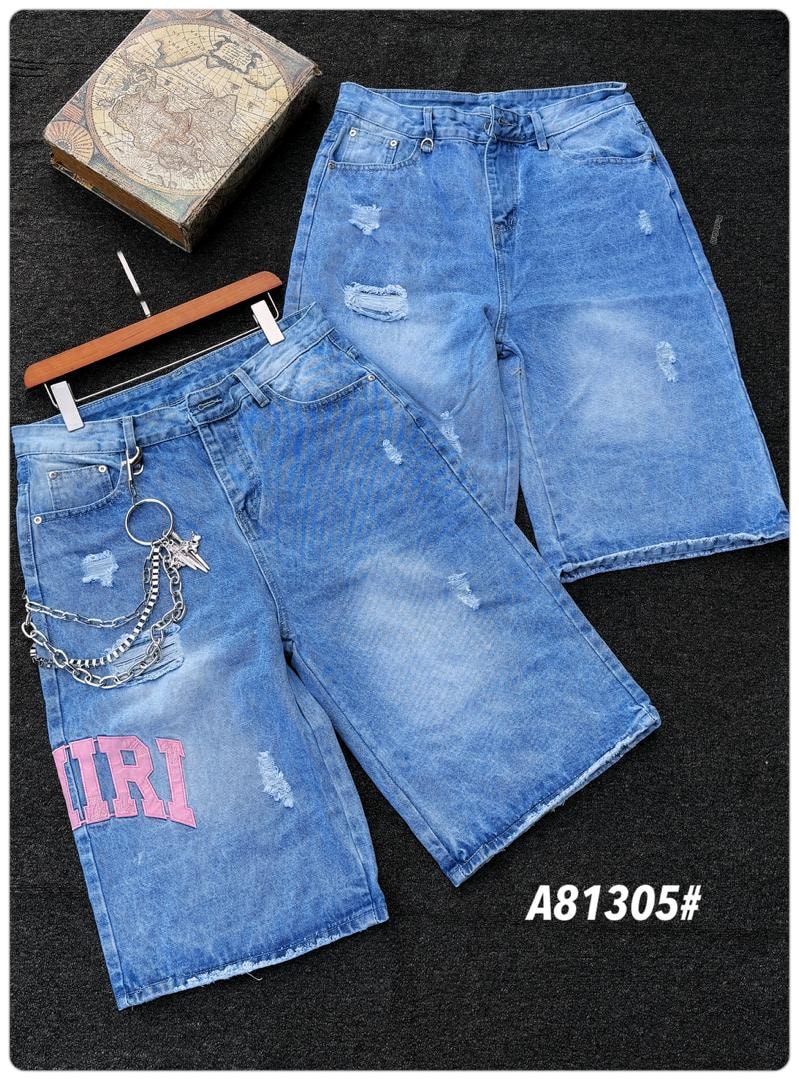 Two pairs of distressed light blue baggy jorts with rips, chains and pink text prints on dark surface.