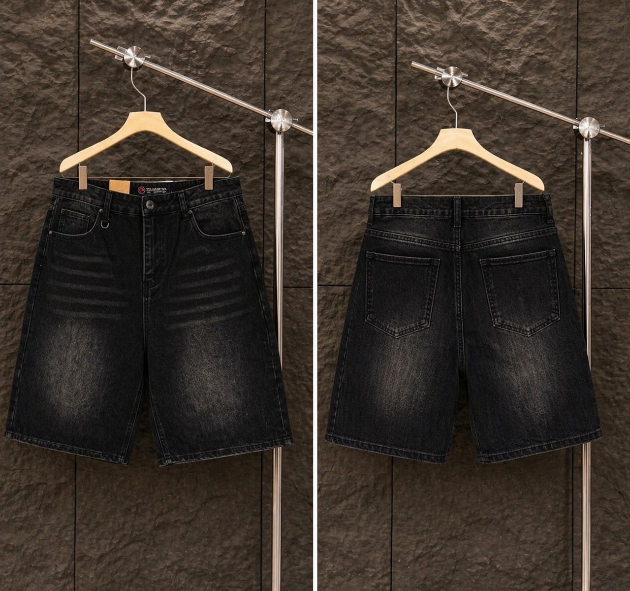 Front and back views of black baggy denim jorts hanging on wooden hanger.