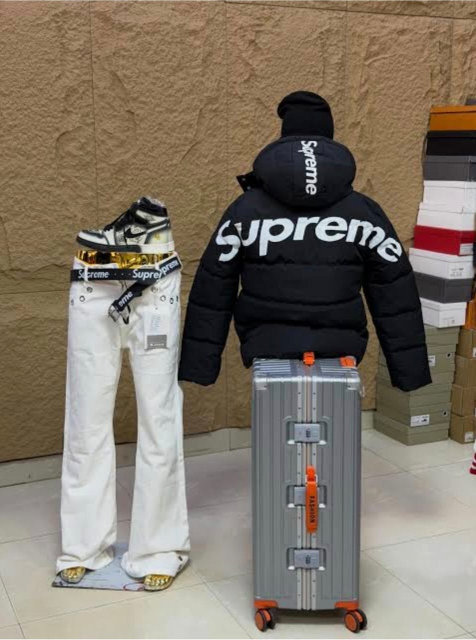 Back view of black Supreme puffer jacket with large Supreme logo.