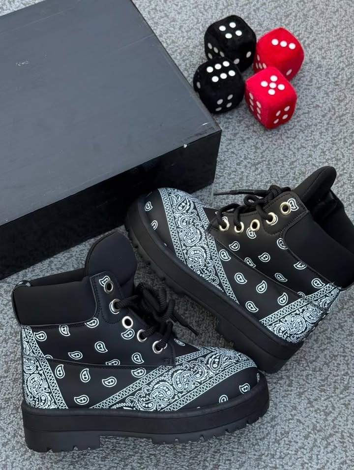 Black boots with white paisley bandana pattern next to black box and dice.