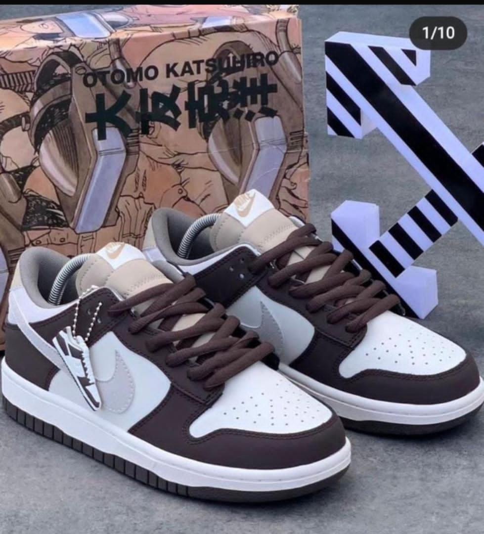 Nike Dunk Low brown and white sneakers with custom box and graphic elements.