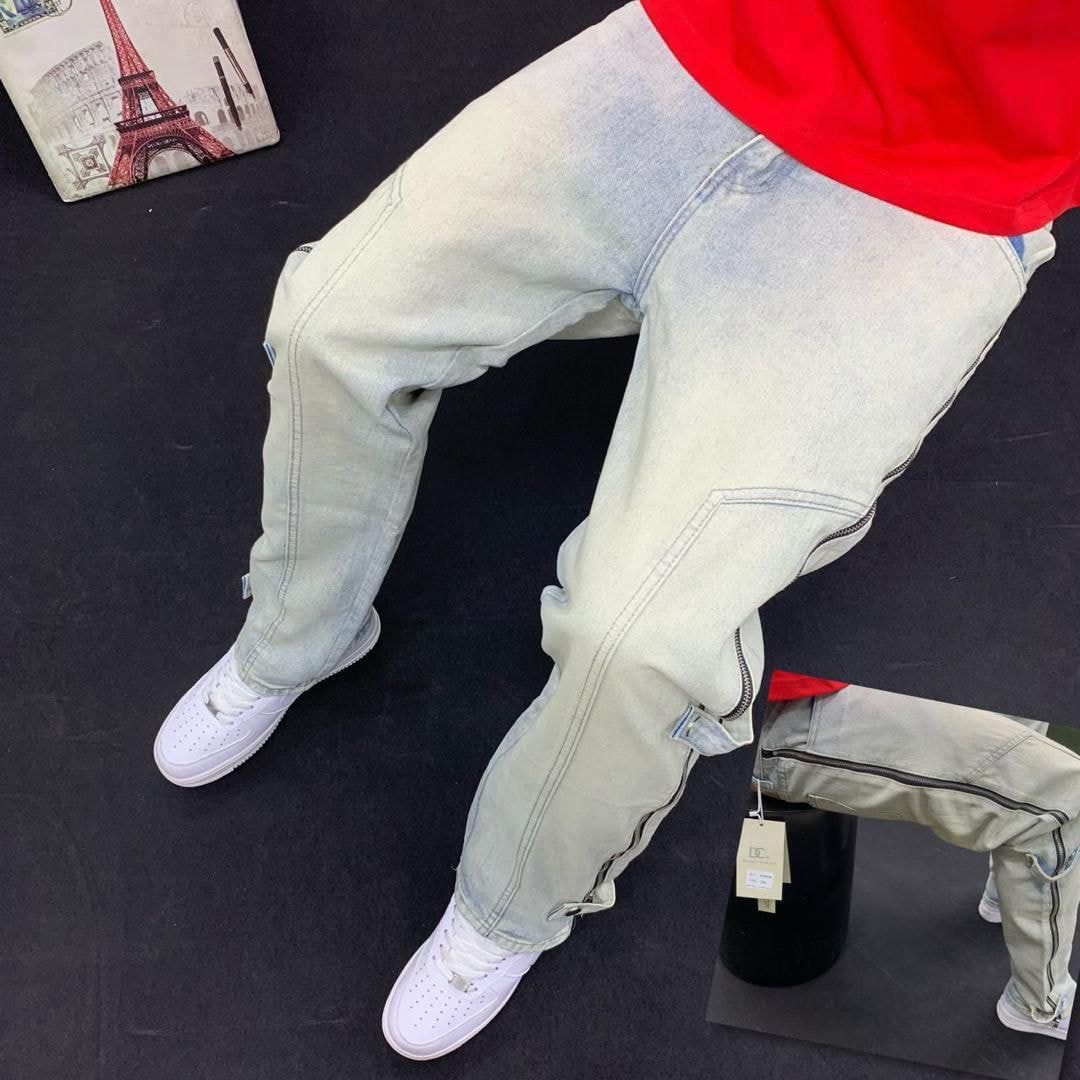 Person wearing light beige cargo baggy jeans with side zippers, red top and white sneakers in multiple angles.