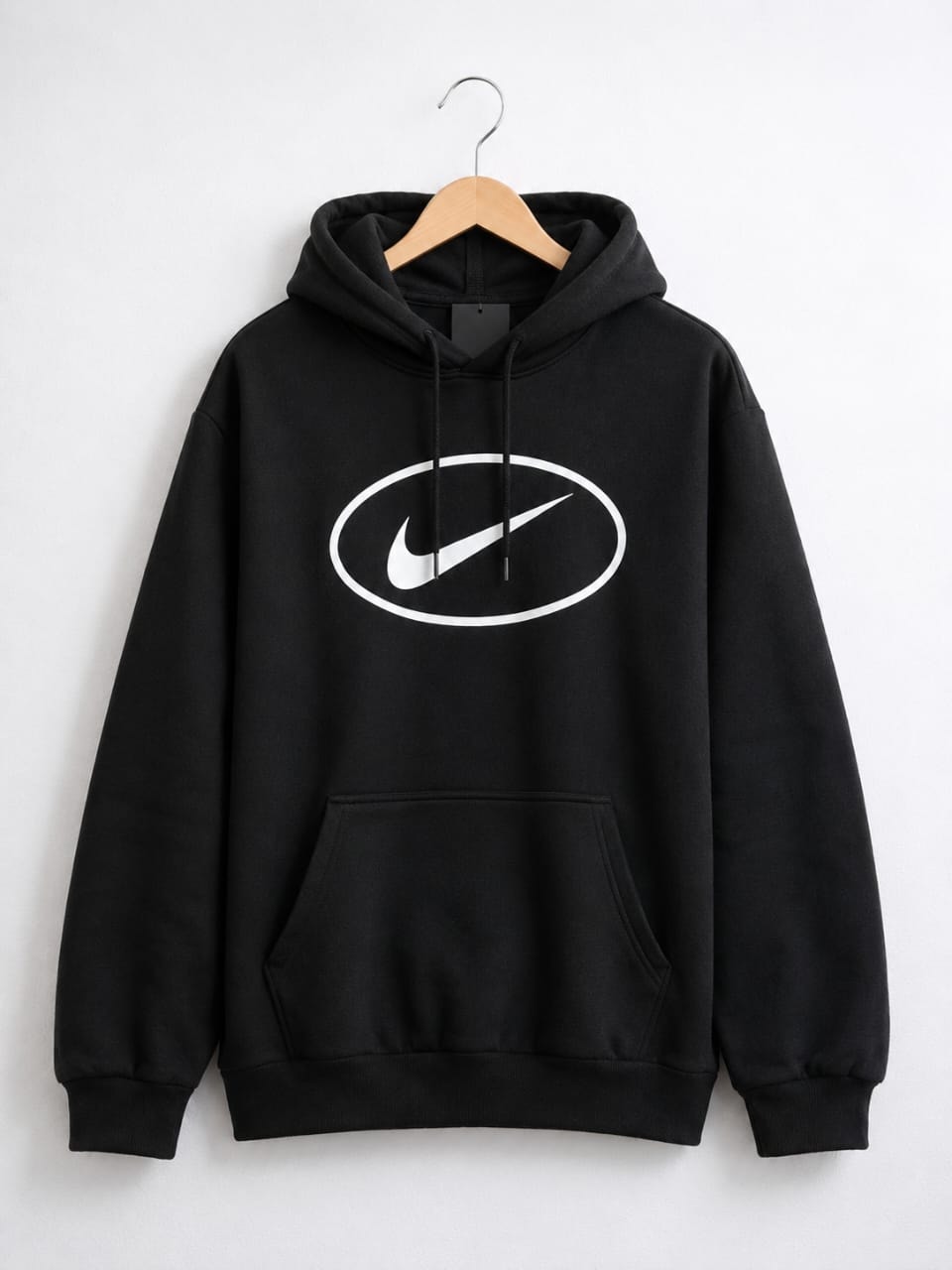 Black pullover hoodie with large white oval Nike swoosh logo on chest.
