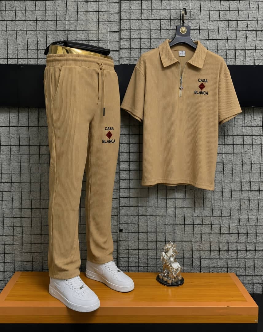 Beige Casa Blanca two-piece polo and jogger set on display stand.