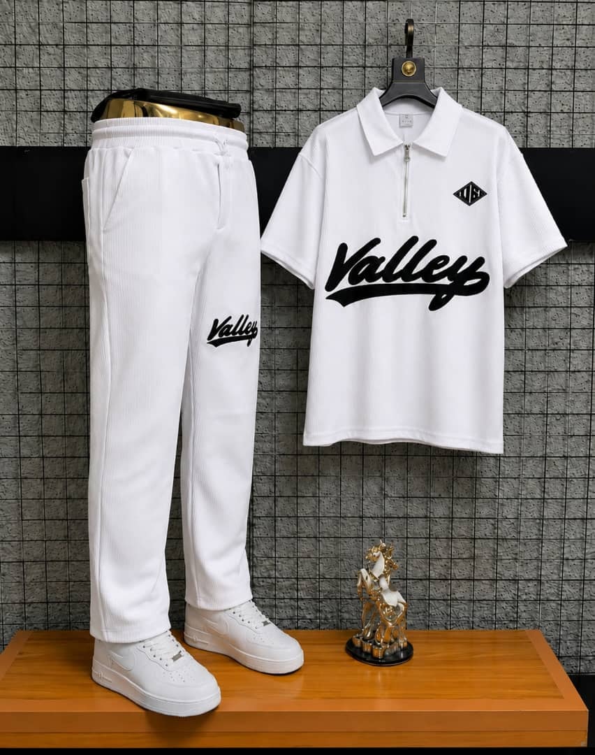 White Valley two-piece polo and jogger set on display stand.