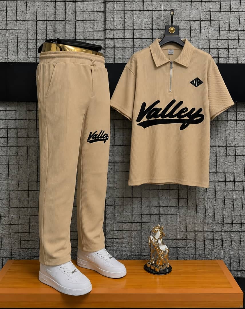 Beige Valley two-piece polo and jogger set on display stand.