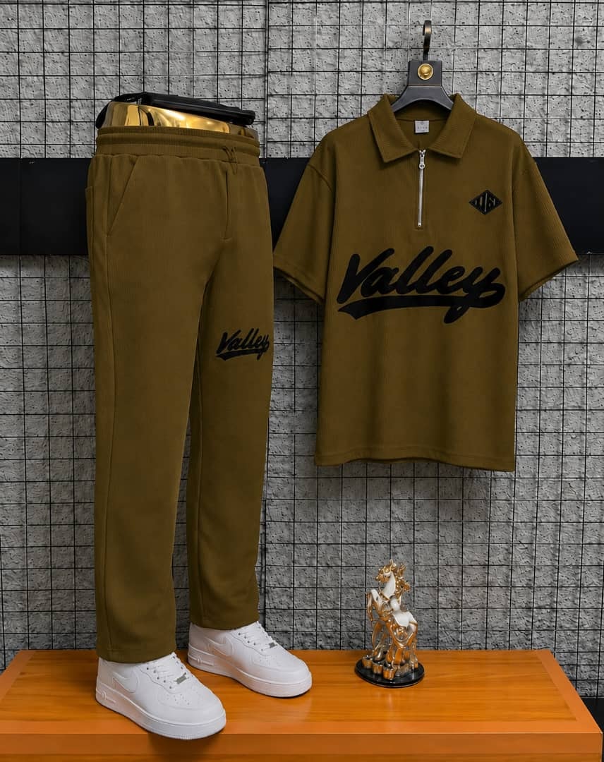 Olive Valley two-piece polo and jogger set on display stand.