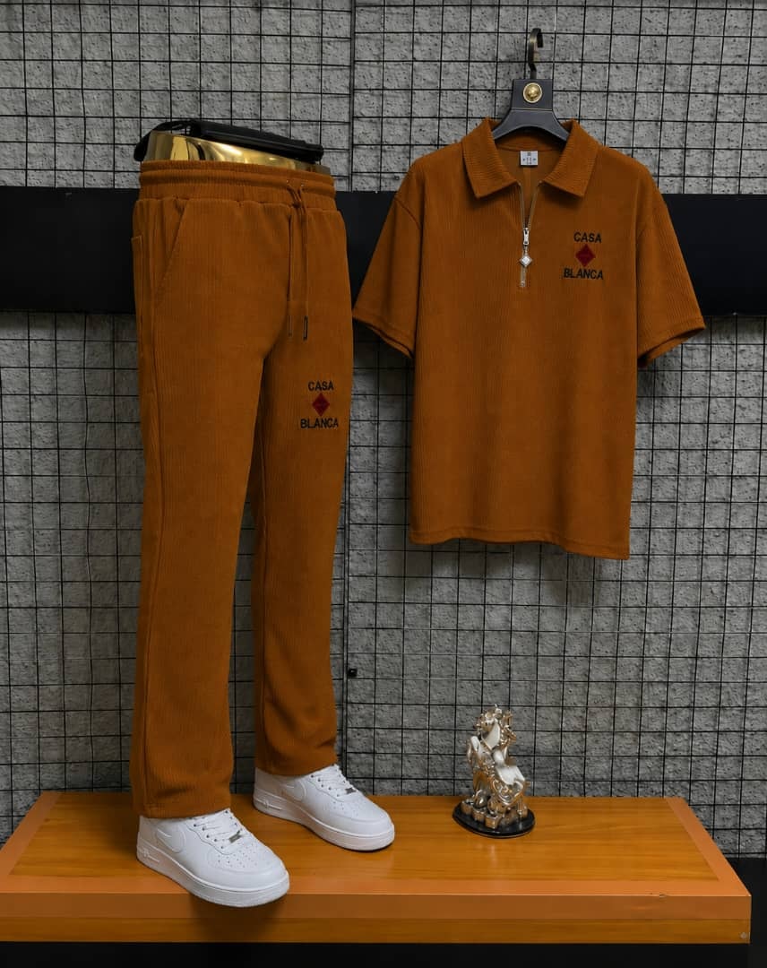 Brown Casa Blanca two-piece polo and jogger set on display stand.