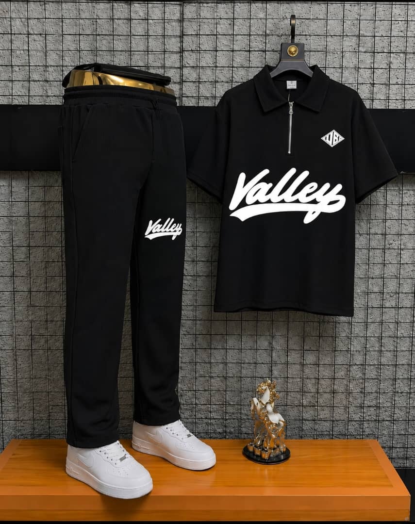 Black Valley two-piece polo and jogger set on display stand.