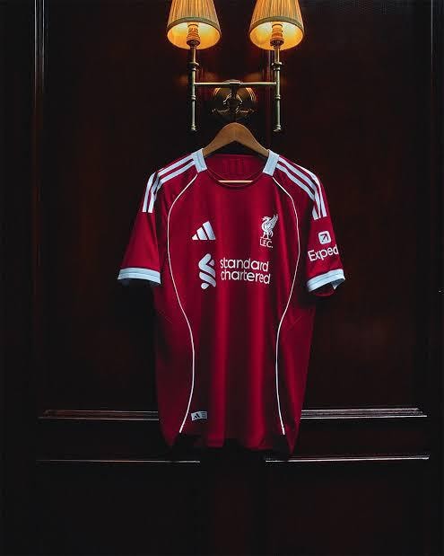 Red Adidas Liverpool FC jersey with sponsor logos and liver bird crest.