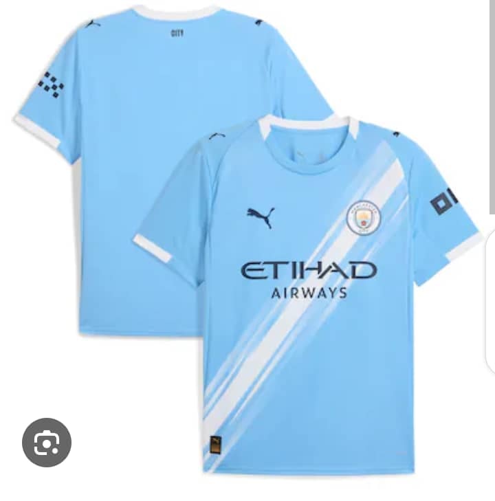 Light blue Puma Manchester City jersey showing front with diagonal white stripes and back view.