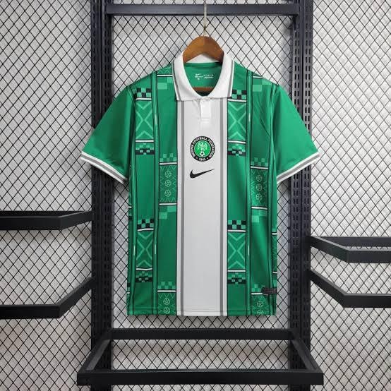 Green Nike patterned polo jersey with white central panel and geometric prints.
