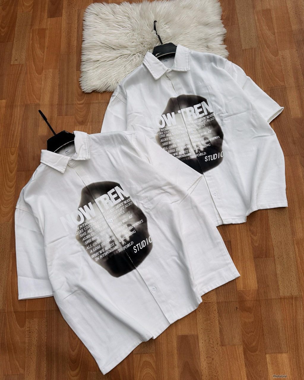 White short sleeve button-up shirt with black abstract graphic and extensive text print.