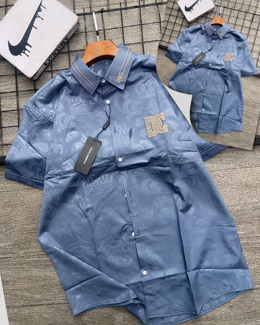 Blue D&G patterned short sleeve shirt with gold logos on collar and chest.