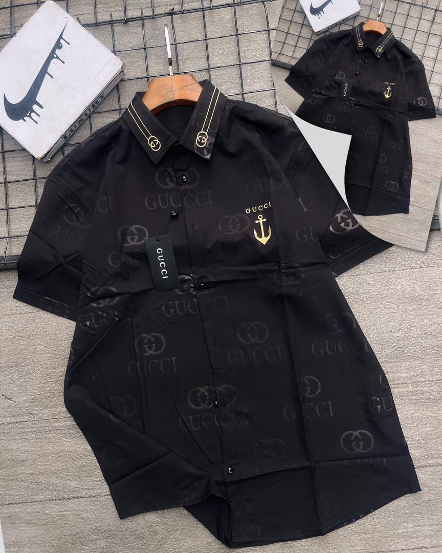 Black Gucci GG monogram short sleeve shirt with gold anchor emblem.
