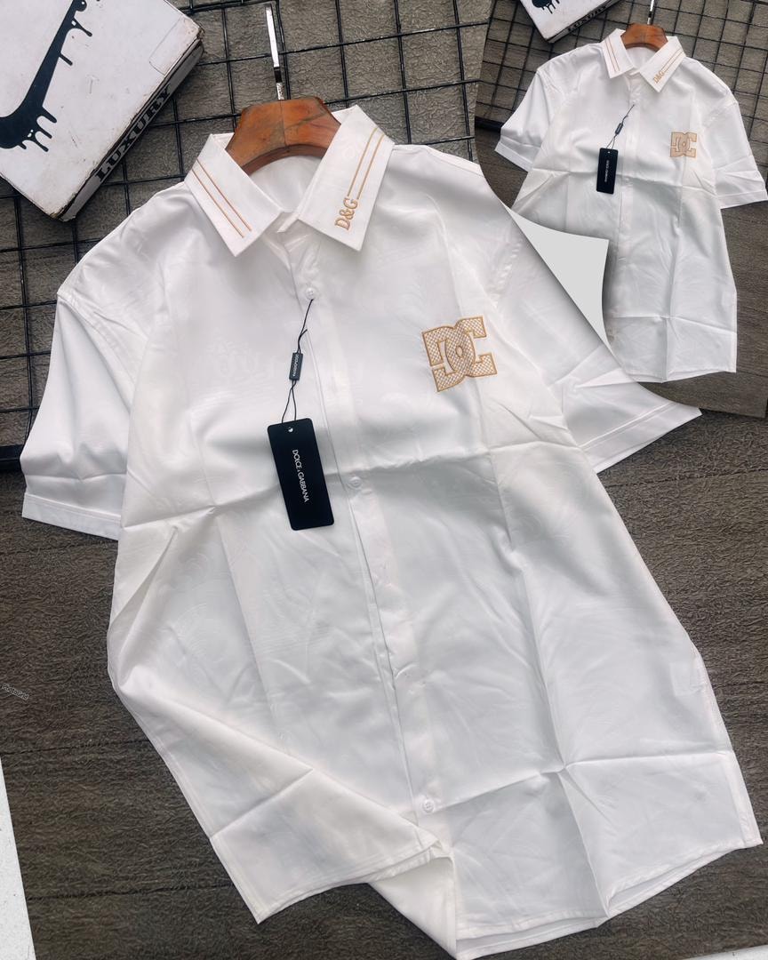 White D&G patterned short sleeve shirt with gold logos on collar and chest.