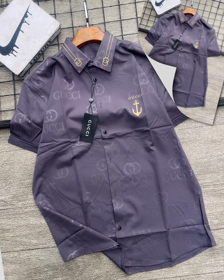 Purple Gucci GG monogram short sleeve shirt with gold anchor emblem.
