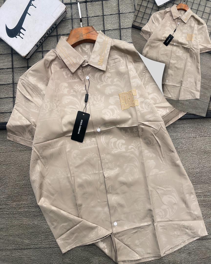 Beige D&G patterned short sleeve shirt with gold logos on collar and chest.