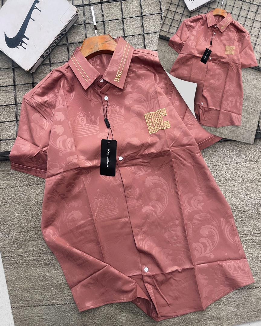 Pink D&G patterned short sleeve shirt with gold logos on collar and chest.