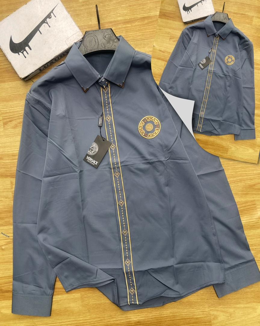 Gray Versace embroidered stripe long sleeve shirt with gold details and tags.