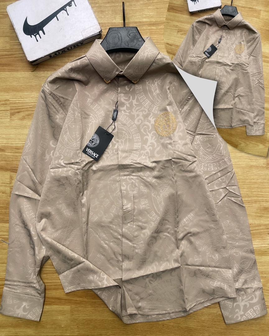Beige Versace all-over print long sleeve shirt with gold Medusa logo and tags.