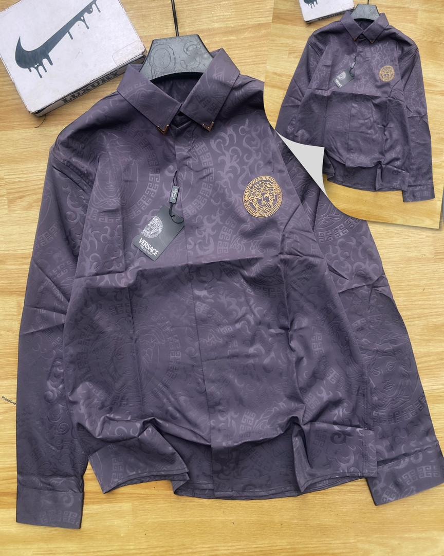 Purple Versace all-over print long sleeve shirt laid flat showing Medusa chest emblem.