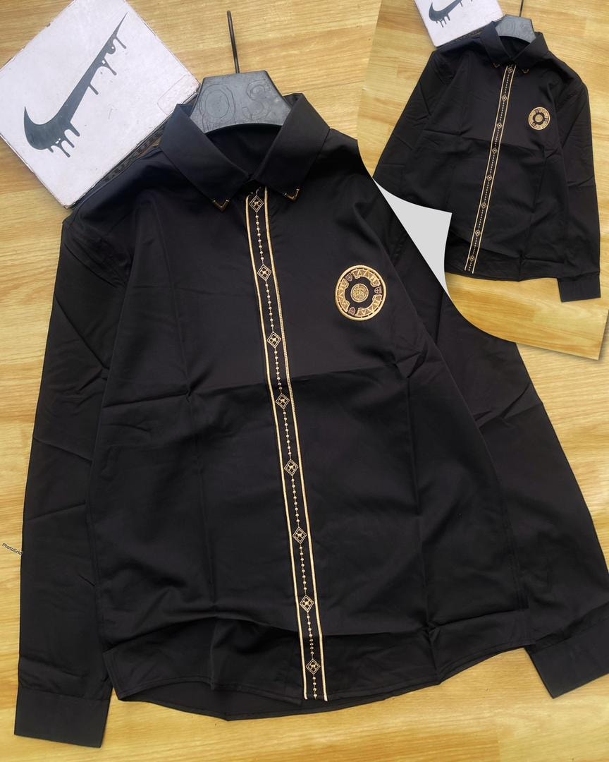 Black Versace embroidered stripe long sleeve shirt with circular chest emblem.