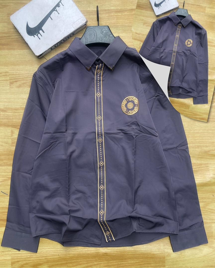 Purple luxury corporate shirt with gold placket trim and circular chest emblem.