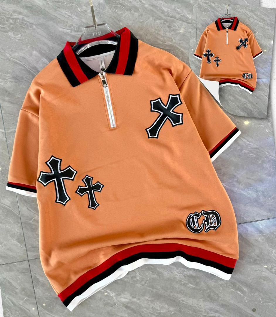 Orange quarter-zip polo shirt with cross embroidery and striped trim.
