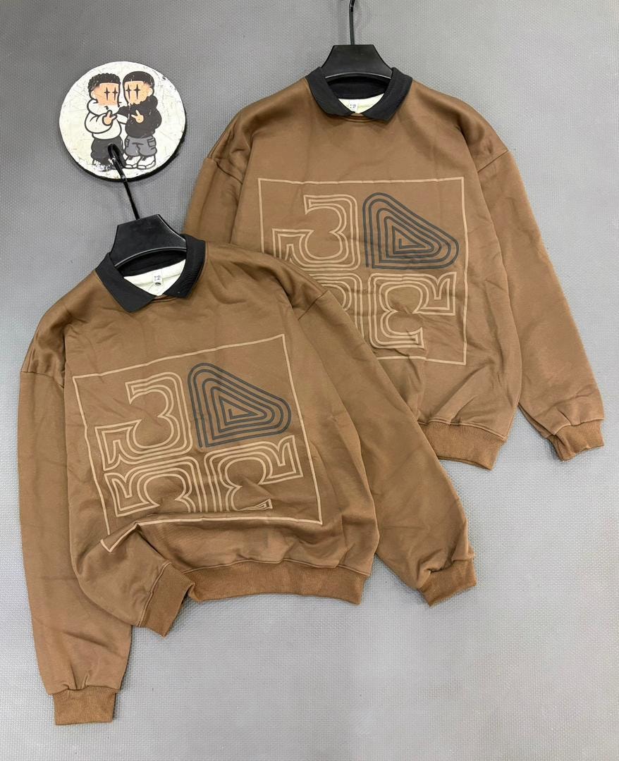 Brown long sleeve sweatshirt with geometric graphic print and black contrast collar.