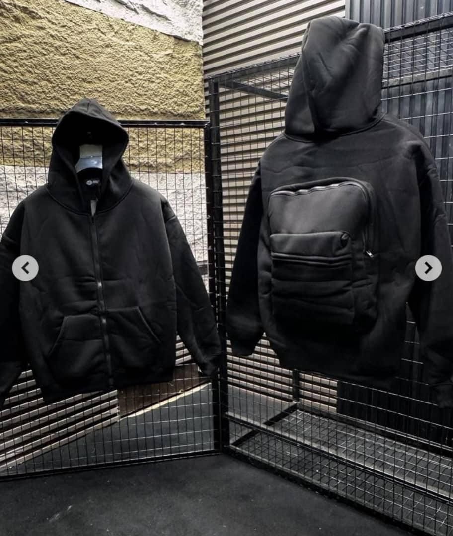 Front and back views of black zip-up hoodie with front pocket and large quilted back pouch.