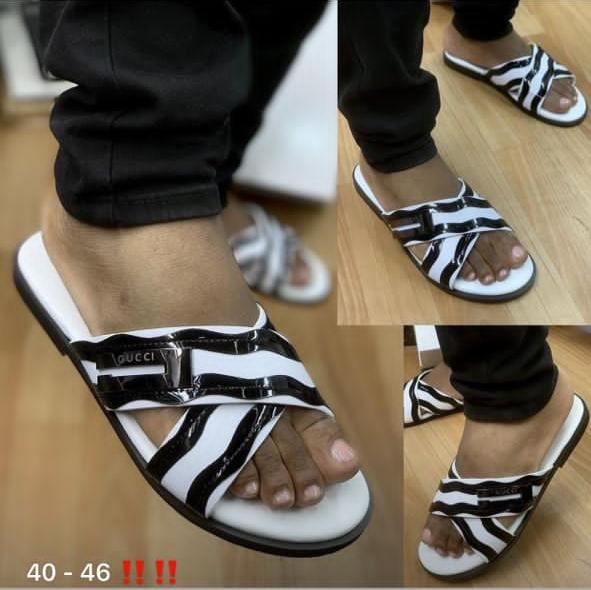 Black and white zebra print Gucci slides worn with black trousers, collage of multiple angles.