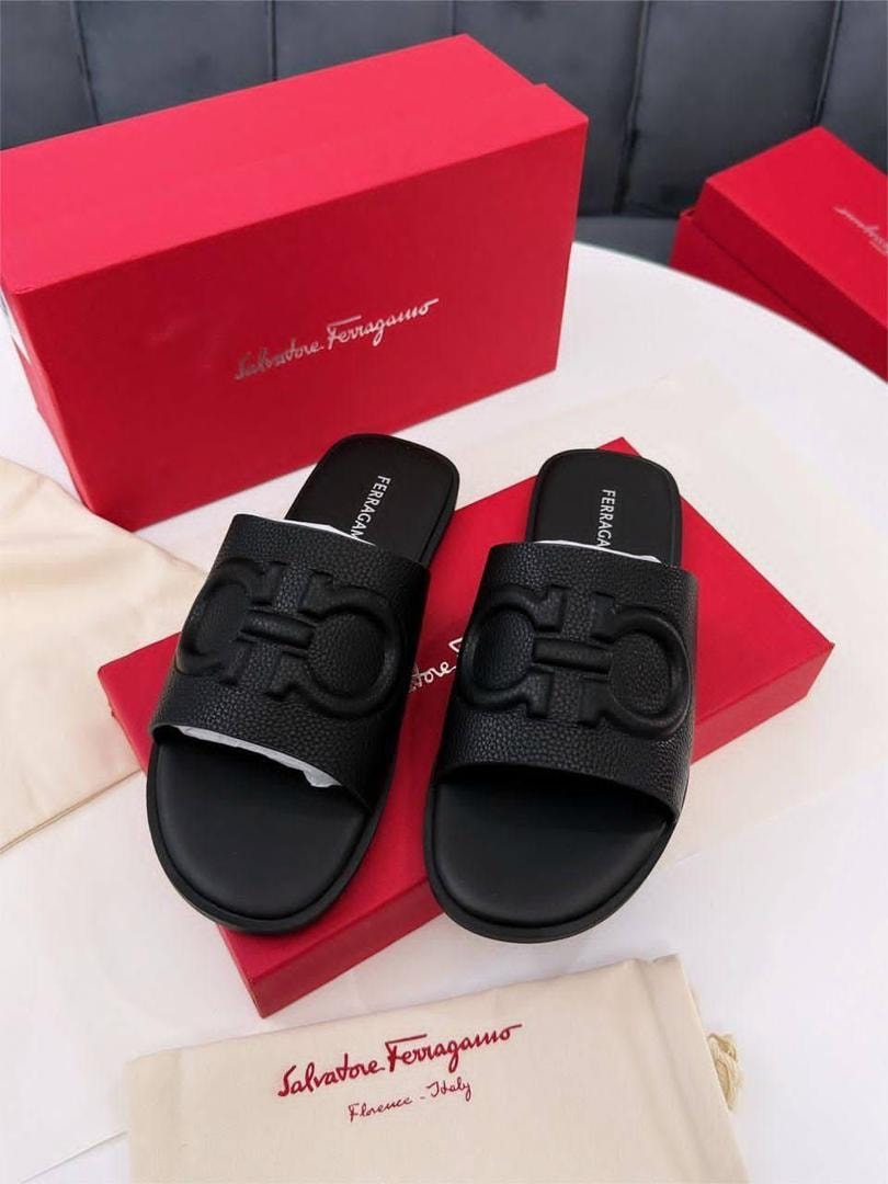 Black Salvatore Ferragamo slides with Gancini logo on red boxes with brand dustbag.