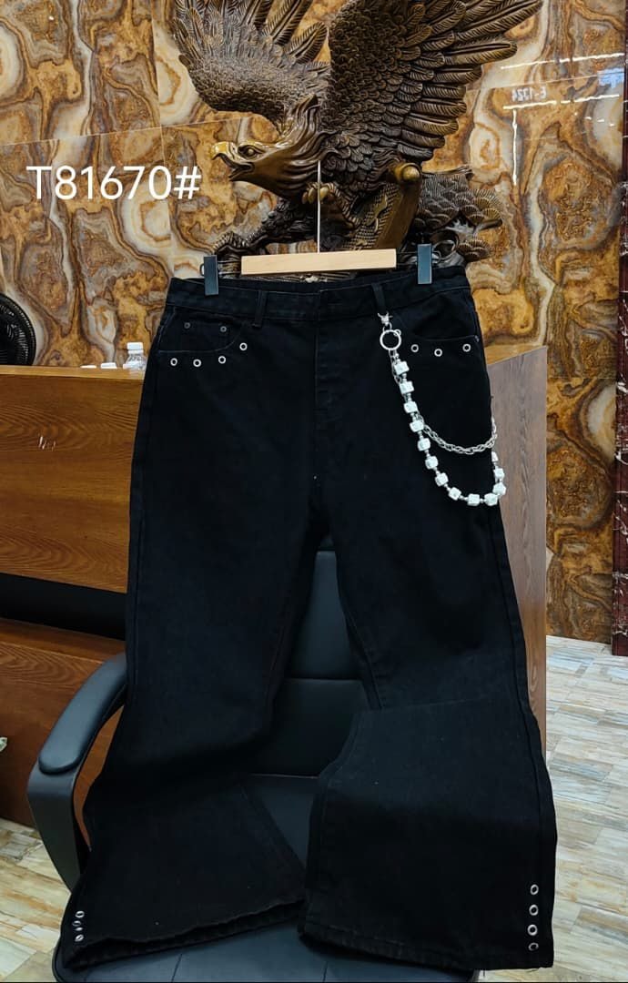 Black baggy jeans with white beaded chain accessory and eyelet details.