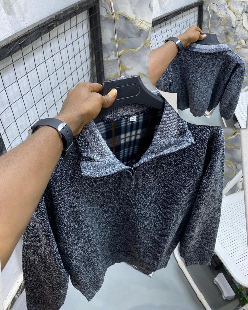 Dark gray textured knit quarter-zip sweatshirt displayed on hanger with striped rib collar.