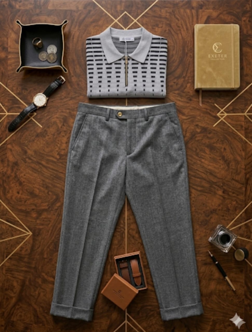 Grey grid and stripe knit polo shirt paired with grey trousers in flat lay with accessories on wooden floor.