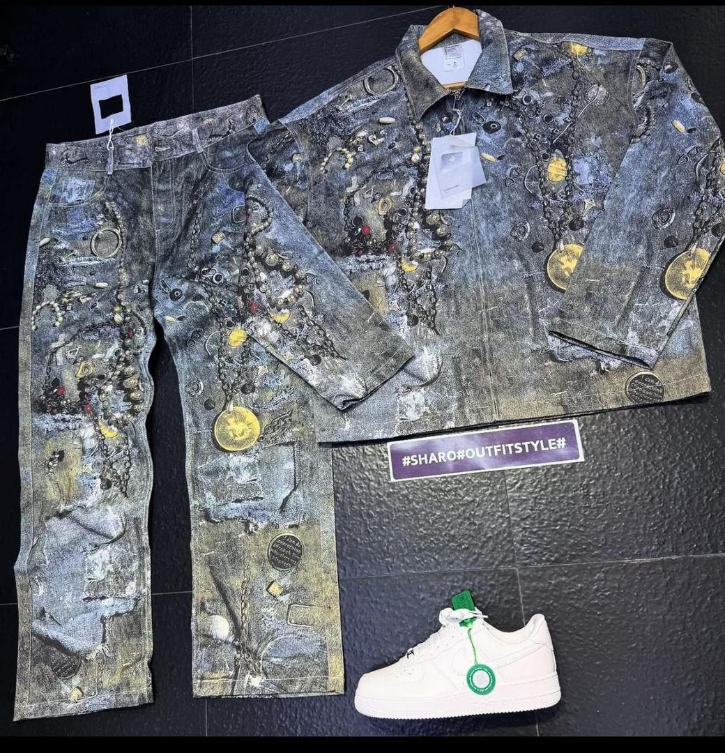 Grey chain and coin print denim jacket and pants two-piece set with white sneakers.