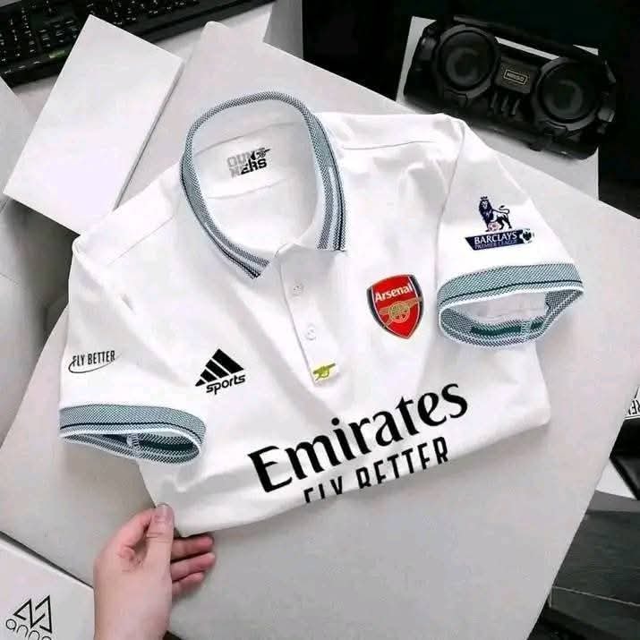 White Arsenal polo jersey laid flat showing all branding details.