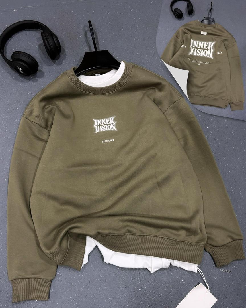 Olive green sweatshirt with INNER VISION print on chest and back inset, displayed with headphones.