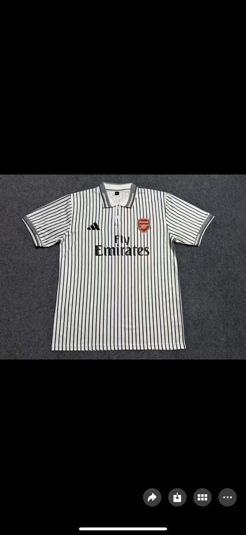 White and black striped Adidas Arsenal Fly Emirates polo shirt laid flat.