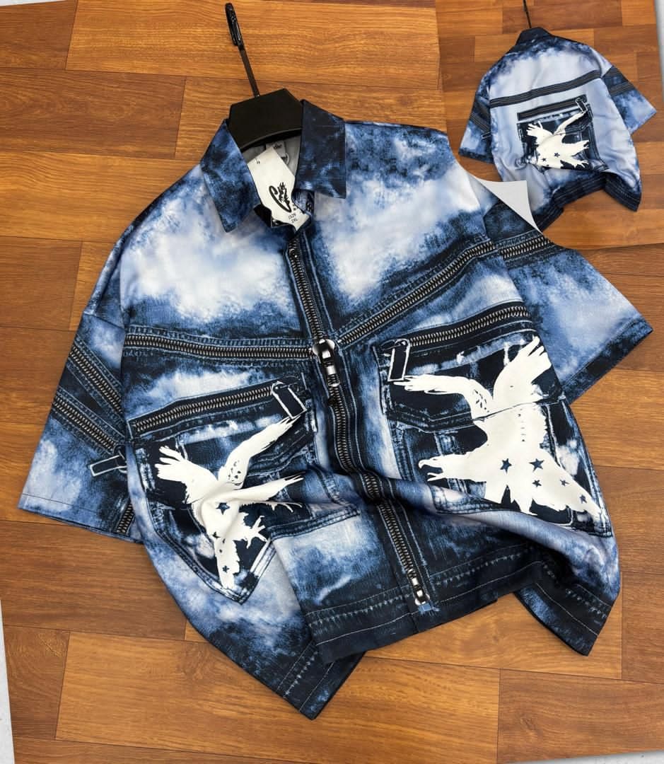 Unisex zip-up shirt in blue bleached denim with white eagle prints.