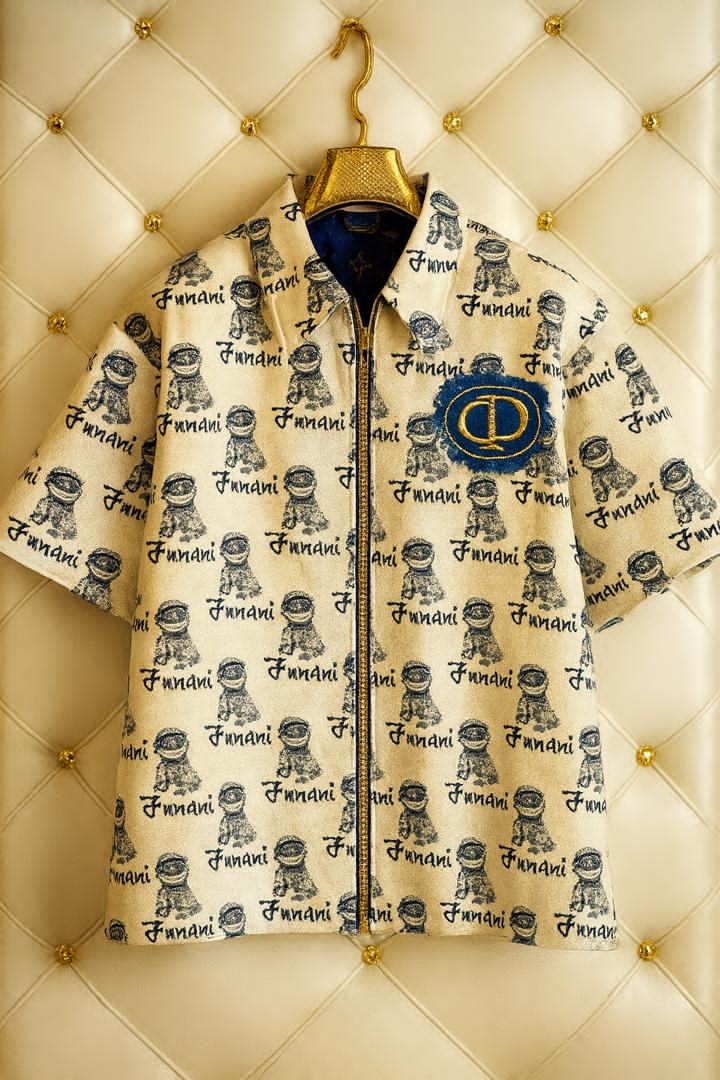 Funani astronaut print zip-up crop shirt on hanger against tufted background.