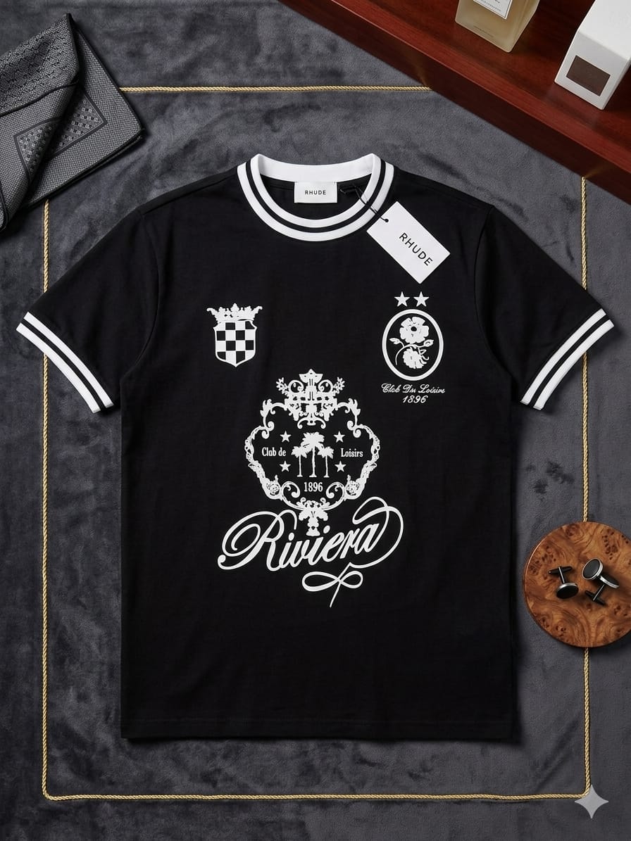 Black RHUDE Riviera graphic t-shirt with white prints, detailed crests and 'Riviera' script, displayed flat.