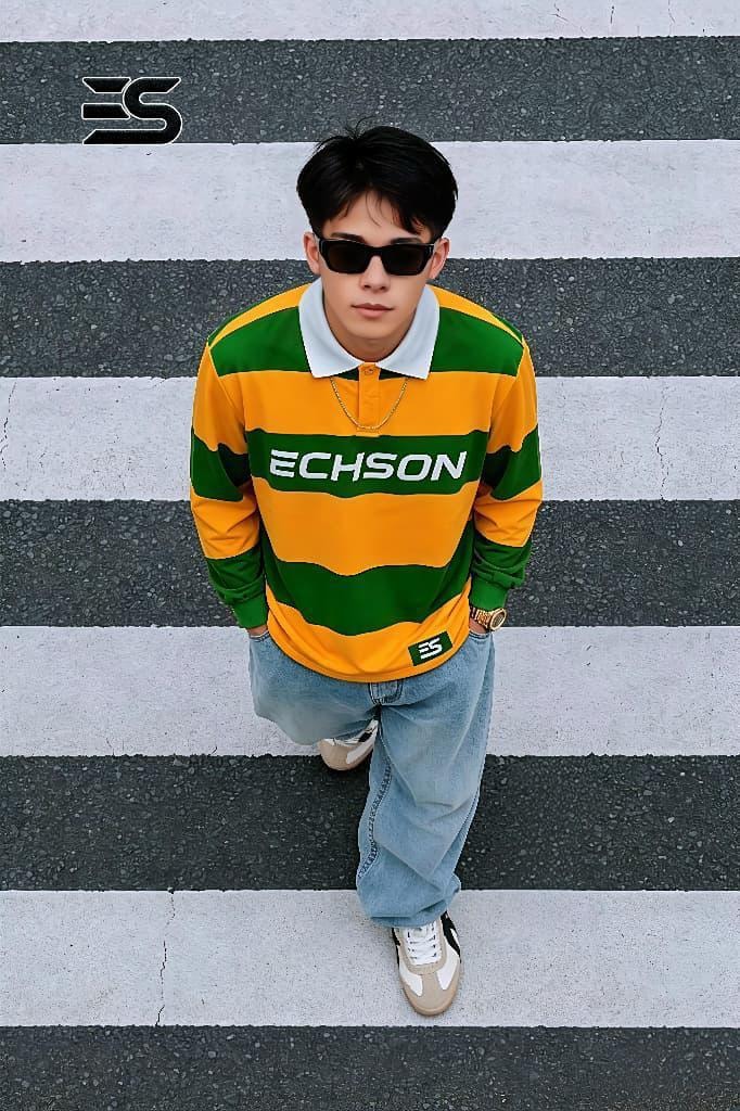 Model wearing green and yellow striped long sleeve polo with ECHSON chest print.